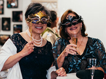 Two women dressed for a masquerade