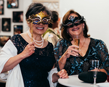 Two women dressed for a masquerade